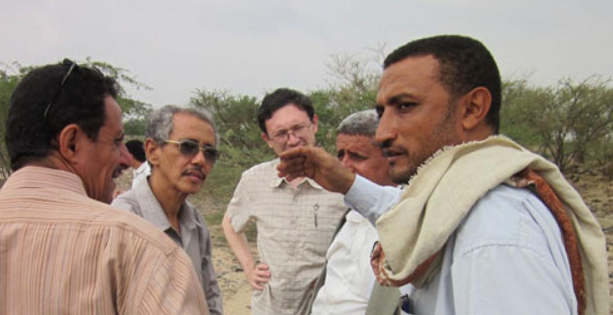 Derek Kim (centre) meets with local farmers in Wadi Zabid