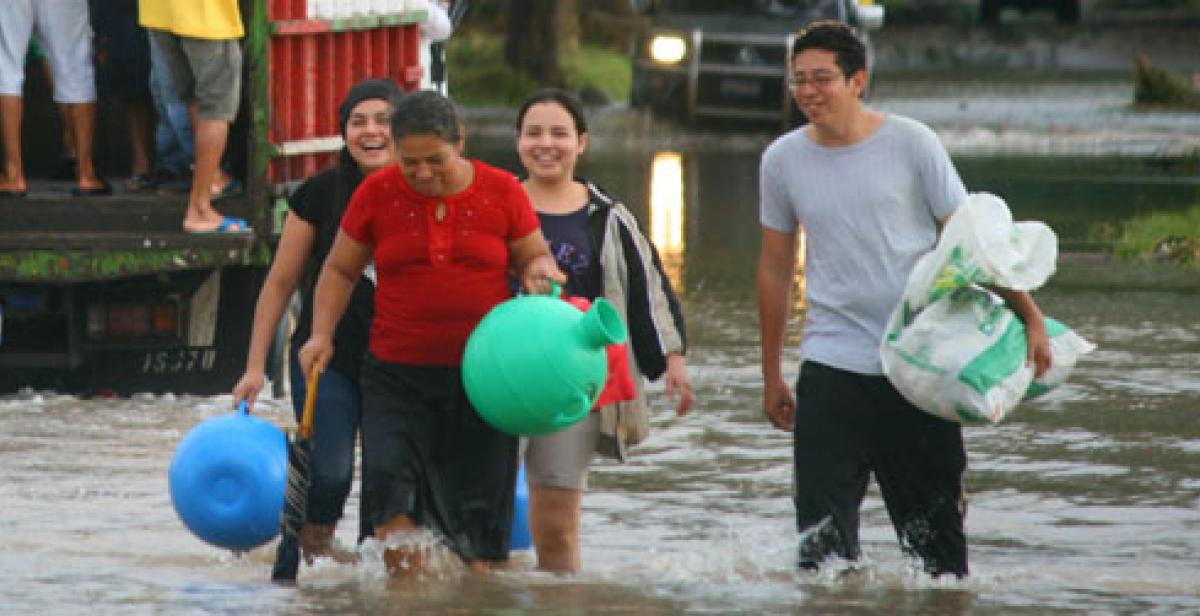 People wading through flood water in San Francisco Menendez, El Salvador