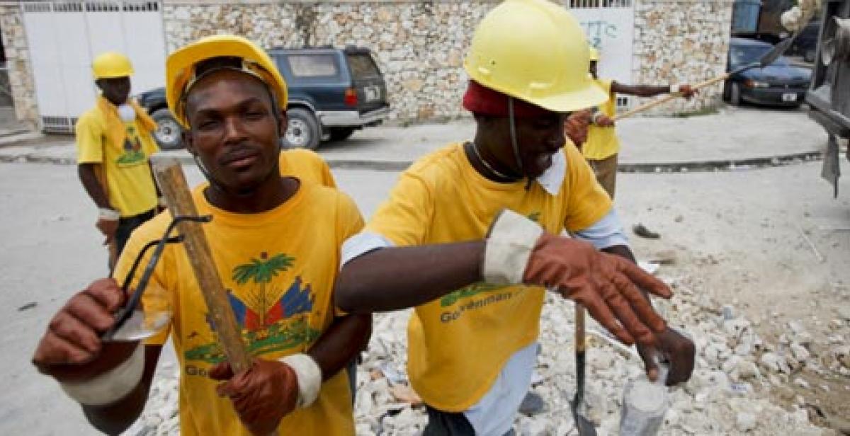 Haitian workers clear rubble in streets of Port-au-Prince