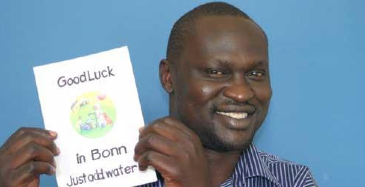 Innocent Ogaba holds a card from supporters in Hertfordshire