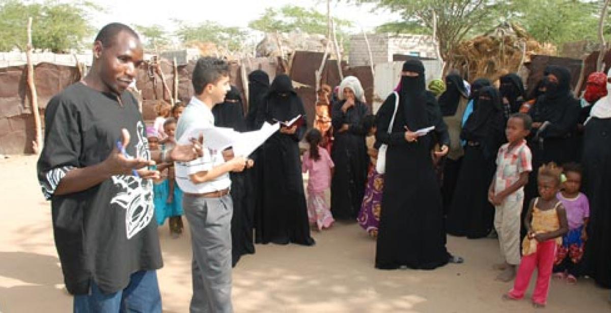 Joseph Aloo discussing community needs with women in Hodeidah Yemen