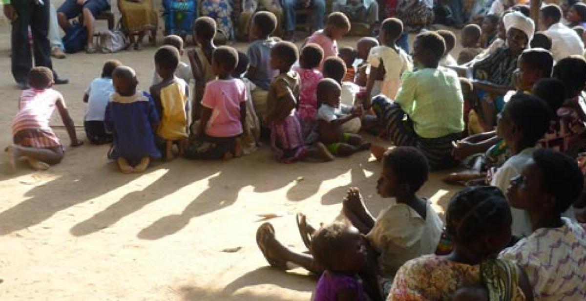 Women and children gathered for a talk in a village in Malawi