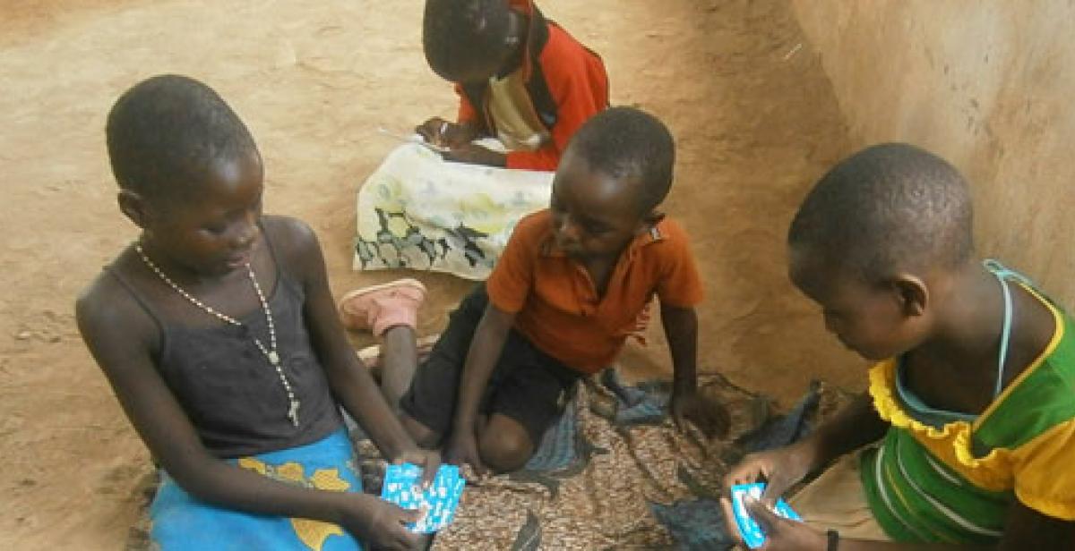 Kids in Malawi playing cards
