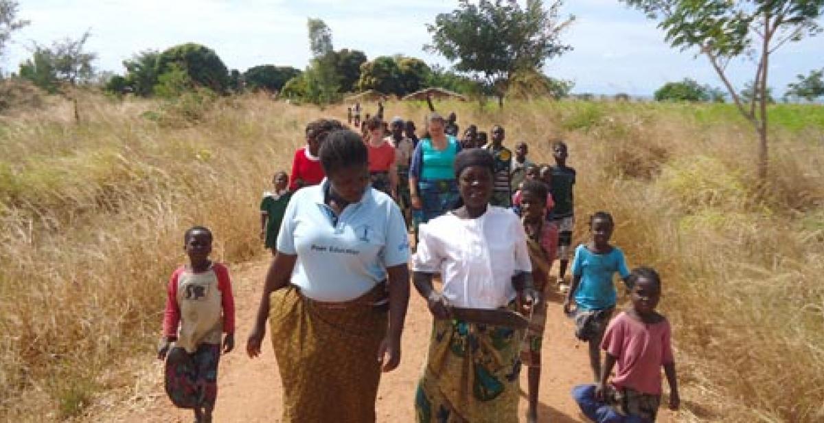 Women walking through a field in Malawi