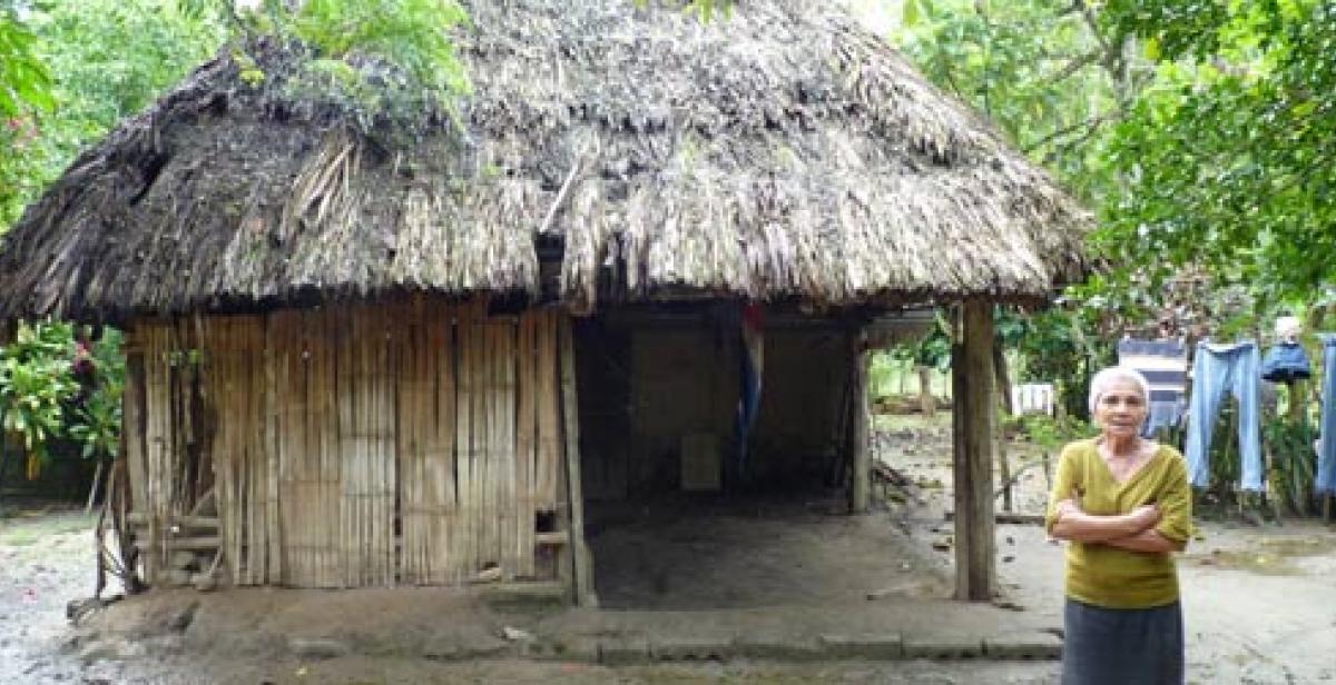 Mélida Tróchez standing by her house, which she has rebuilt four times.