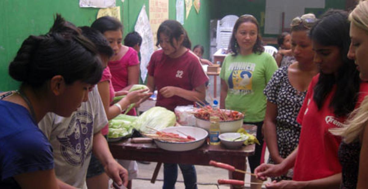 Preparing food at market stall