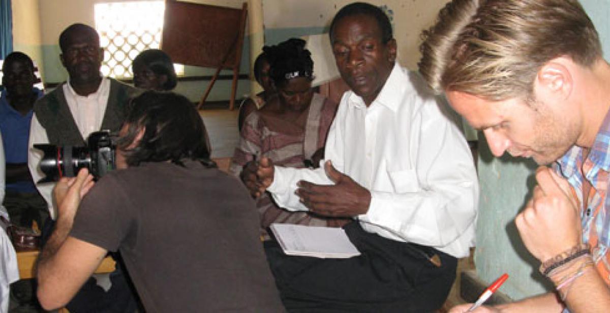 Photographer and journalist meeting HIV support group in Malawi