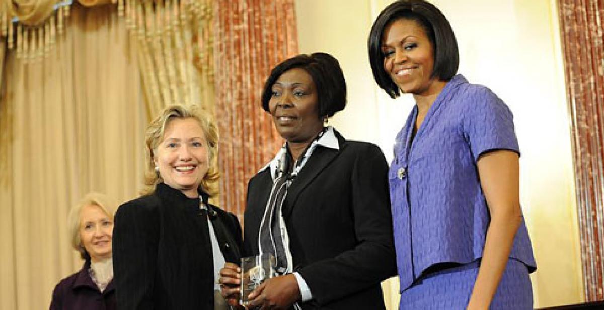 Sonia Pierre (centre) with Hillary Clinton and Michelle Obama