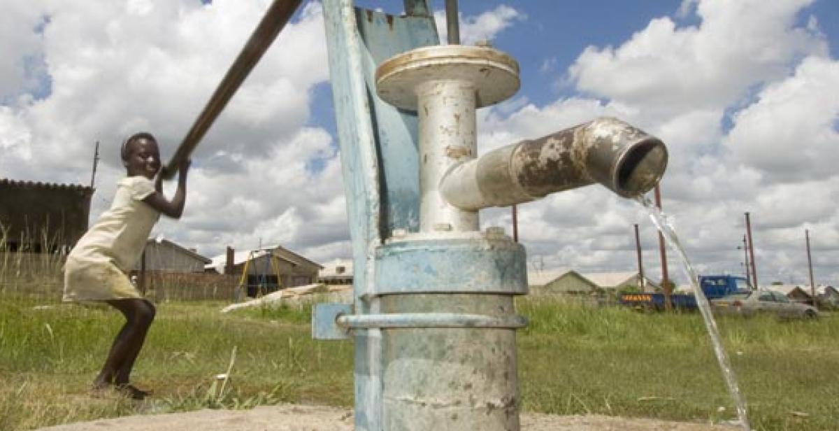 Virginia Jarusa using water pump in Zimbabwe village