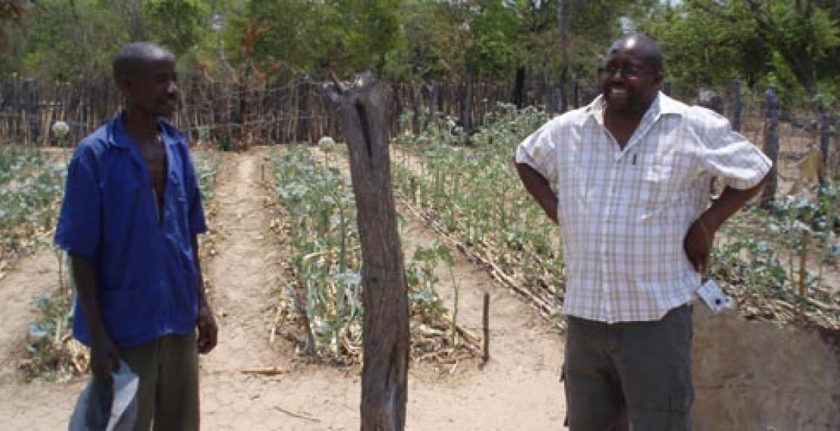 Development worker Cliff Maunze (right) with a farmer in Zimbabwe