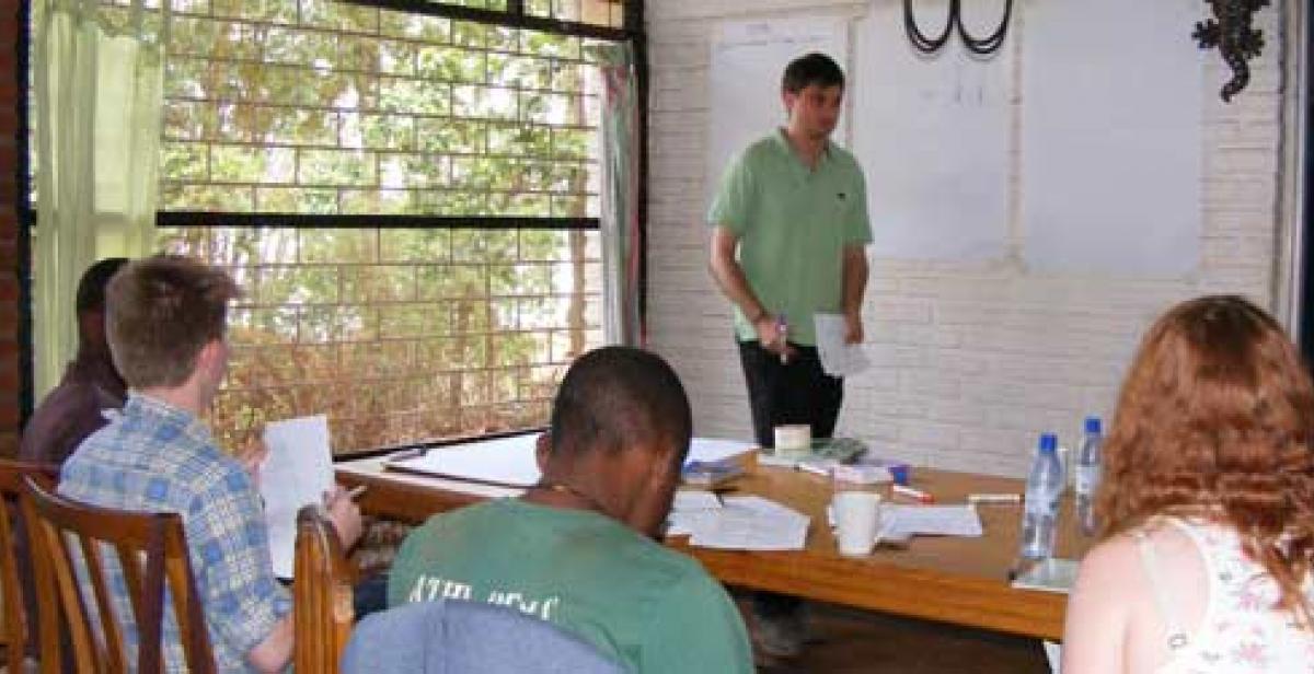 Sam, a UK volunteer, helps the rest of the UK group to learn Chichewa 