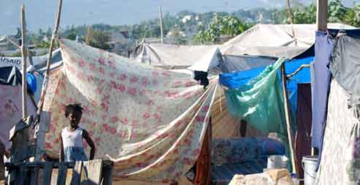 Haitian women selling mangoes amid the rubble