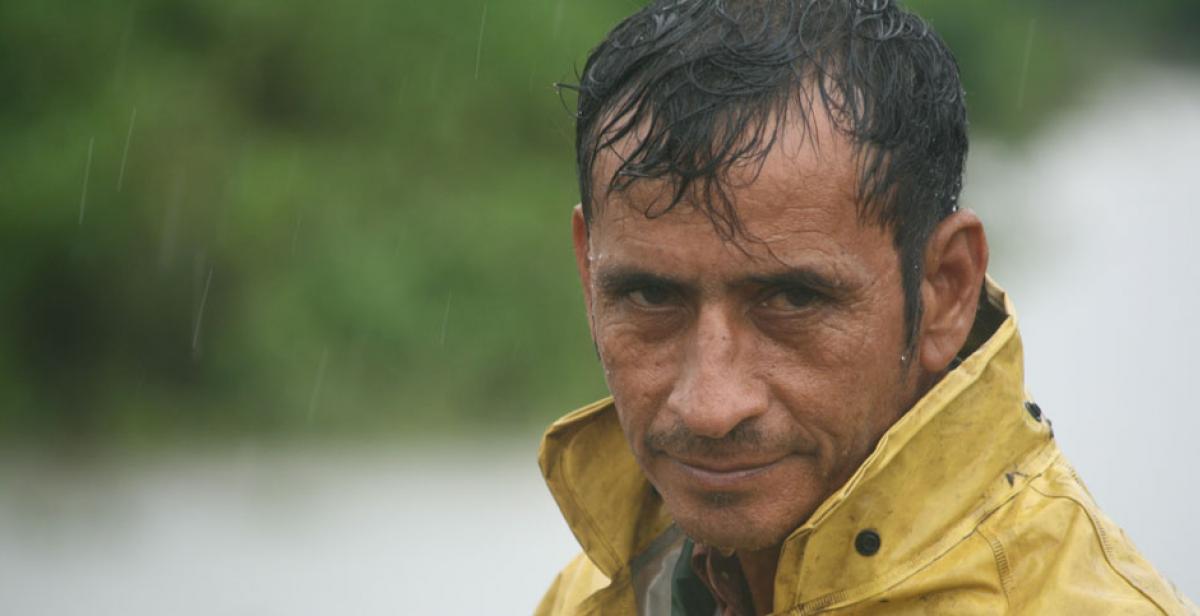 A man endures rainfall during a tropical storm