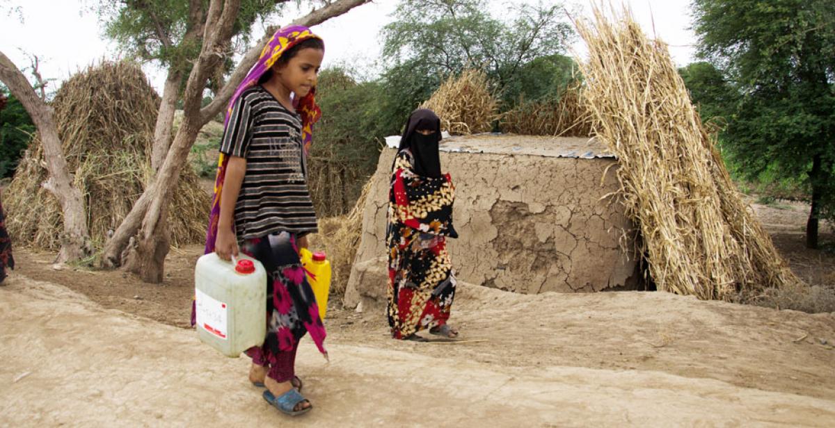 Rabab Aziz, age 7, carrying water to from the village well, Zabid, Yemen