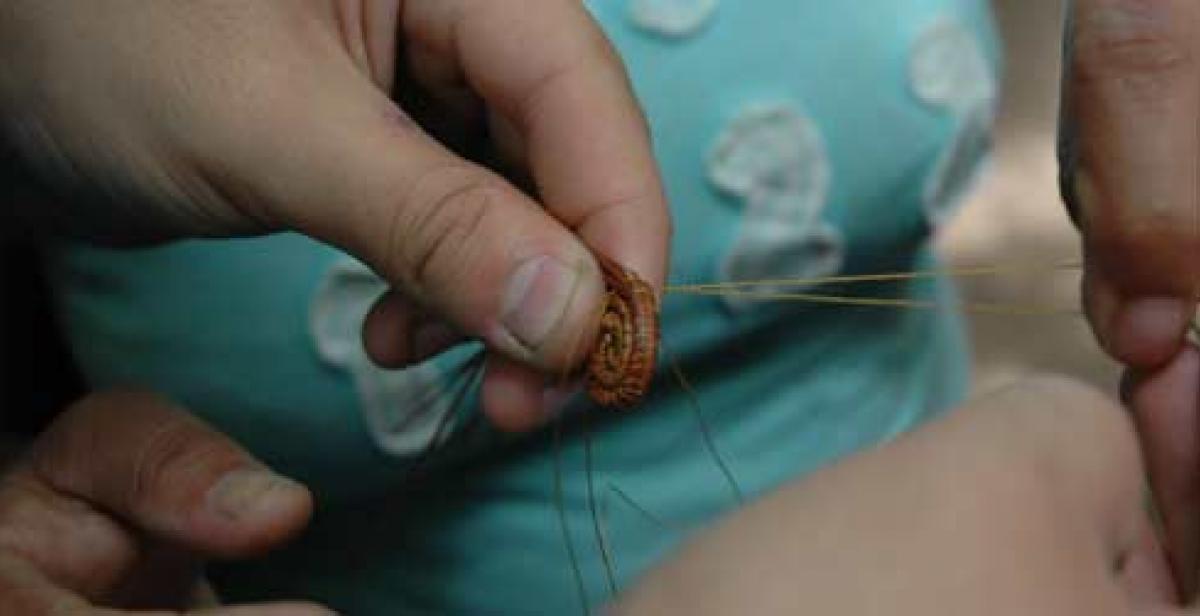 Picture of hands making pine-needle crafts