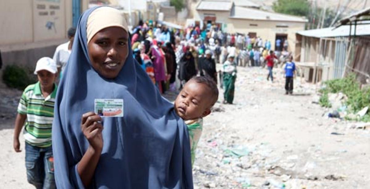 Somaliland woman holds ID card in queue to vote