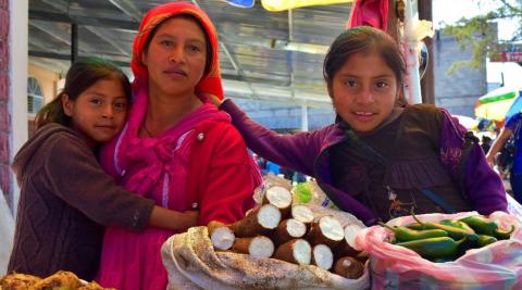 A Lenca woman and her two daughters selling their produce at a market in La Esperanza