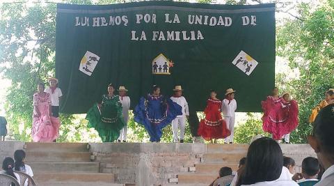  Children dancing a folkloric dance on stage for parents, teachers, and fellow pupils