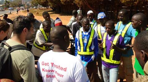 Nowras, Emily and George conducting a peer education session educating bicycle taxi operators about HIV and AIDS, STI’s, HTC and positive living