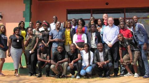 Smiling faces of participants during the Alumni Conference captured outside the venue for the event