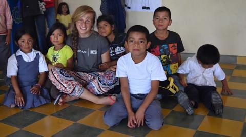 ICS volunteer with local school children at the event