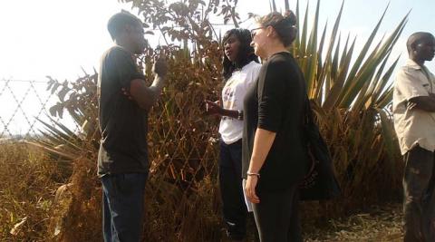 Sally and Mercy discussing sexual reproductive health services with a bicycle taxi operator