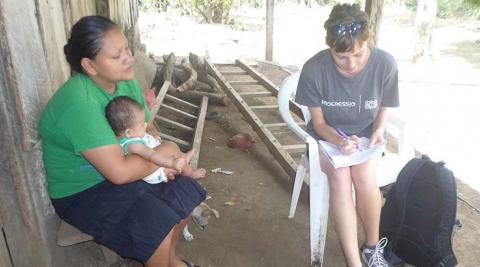 An ICS volunteer surveying community members