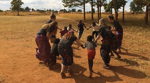 UK volunteers playing and singing songs with the children in Champhira 