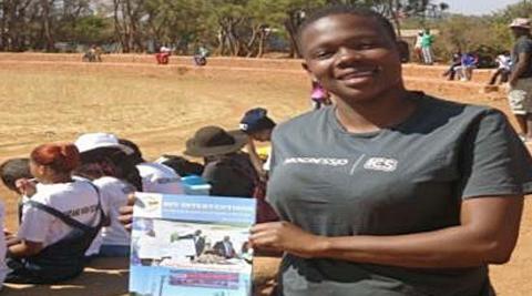 Holding a sample of books we were distributing during the Y.E.S League