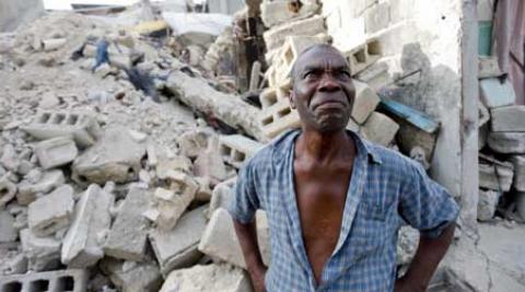 Wilbert Joseph surveys the rubble of his former home