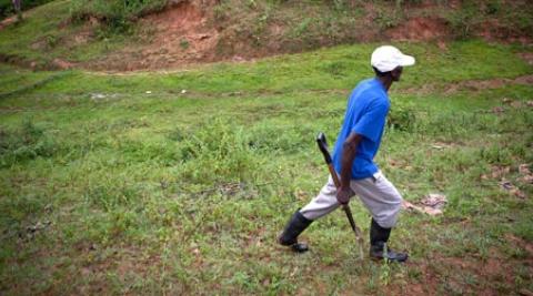 Farmer crosses a field in Lamine, Haiti