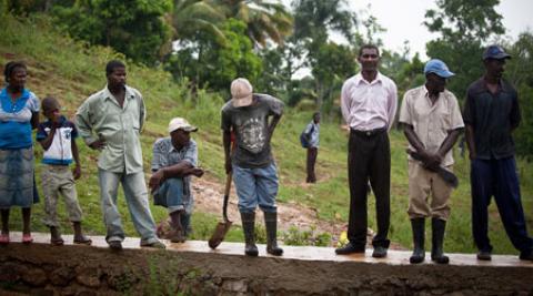 Villagers in Lamine Haiti standing on flood wall