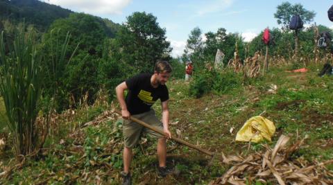 ICS volunteer Edward Maddocks digging a farm field