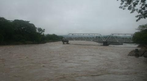 Bridge damaged by floods on El Salvador border