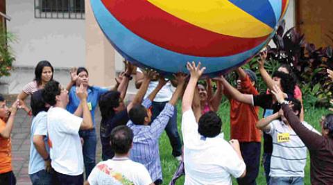 People holding up a coloured ball