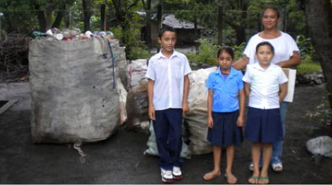 Children in El Salvador with bag of plastic bottles