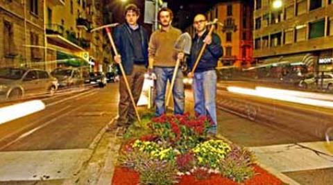 Guerilla gardeners pose by their new gardens in the dead of night