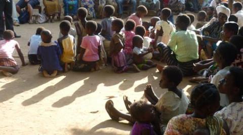 Women and children gathered for a talk in a village in Malawi