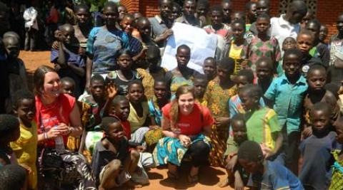 ICS volunteers Jessie O’Keefe and Jenny Vaughan with young people in the village