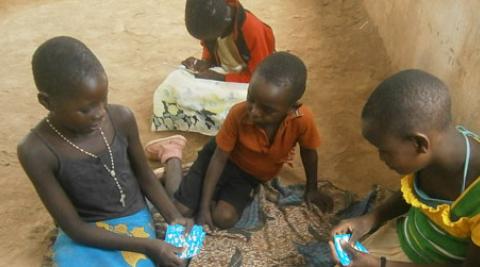 Kids in Malawi playing cards