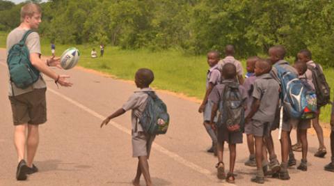 Progressio ICS UK volunteer with school children in Zimbabwe