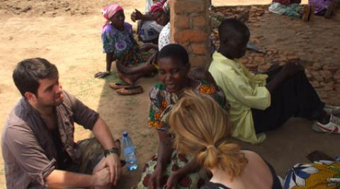 ICS volunteers talking to villagers in Malawi