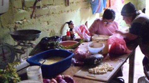 Women preparing a meal at the 'comedor' in Villa El Salvador, Peru