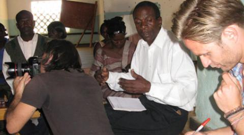 Photographer and journalist meeting HIV support group in Malawi