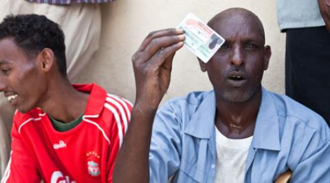 A man holds up his voter ID card in Somaliland