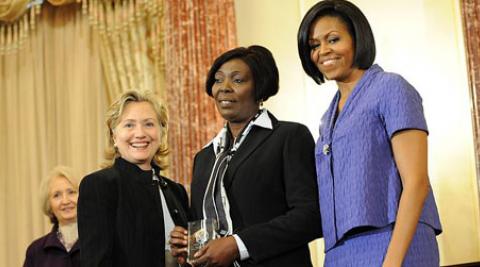 Sonia Pierre (centre) with Hillary Clinton and Michelle Obama