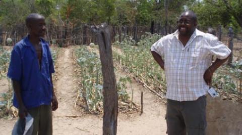 Development worker Cliff Maunze (right) with a farmer in Zimbabwe