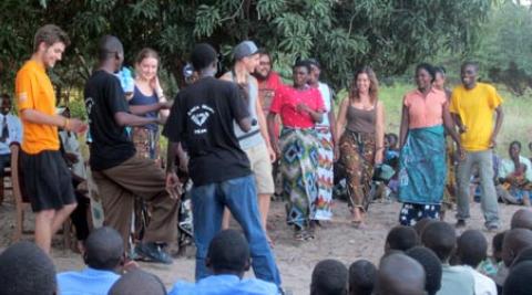 Volunteers and villagers dancing