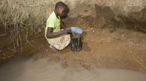 Girl collecting water in Zimbabwe