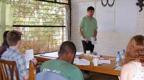 Sam, a UK volunteer, helps the rest of the UK group to learn Chichewa 